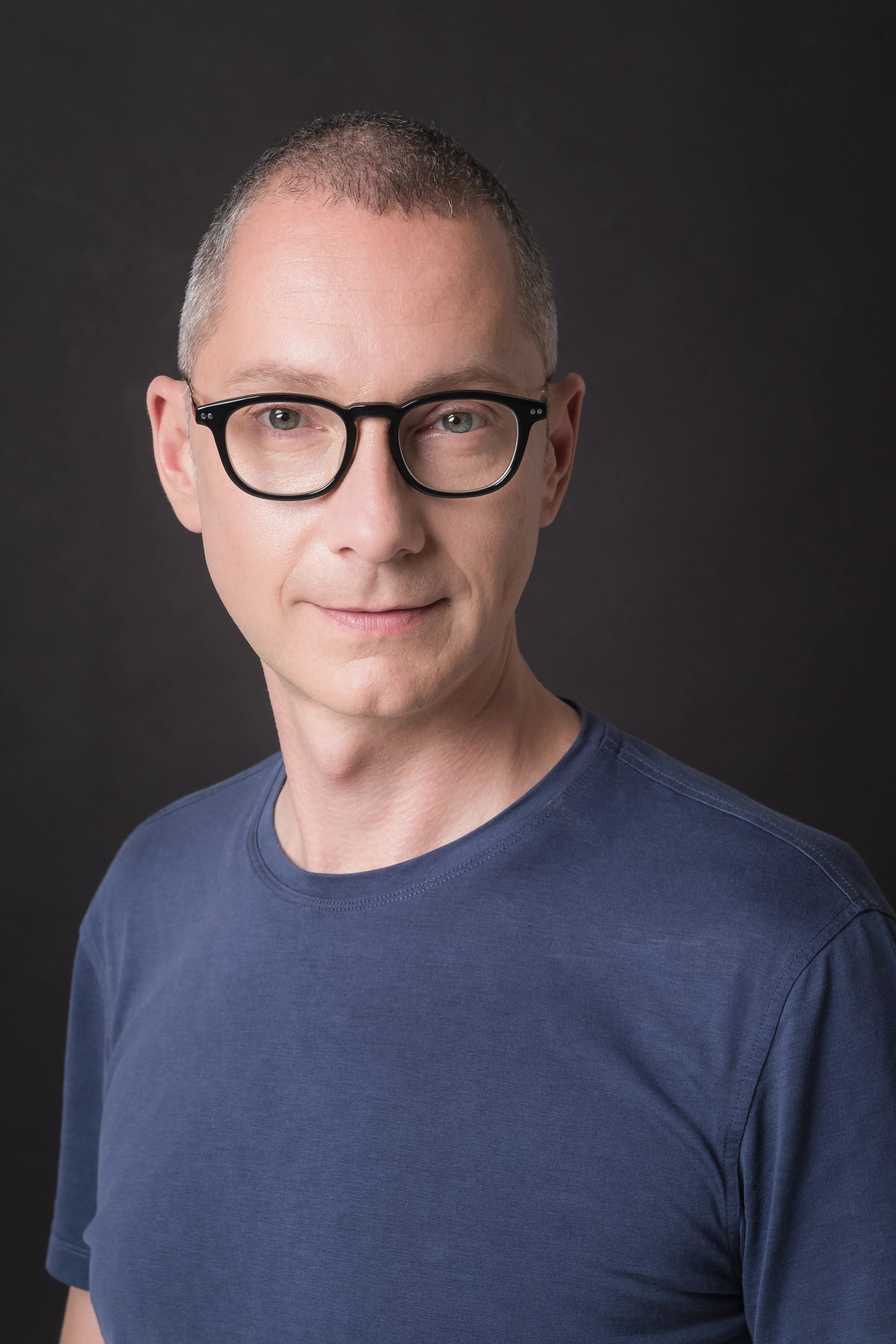 Borys Lozhkin Headshots - Alternate casual portrait with glasses, dark backdrop