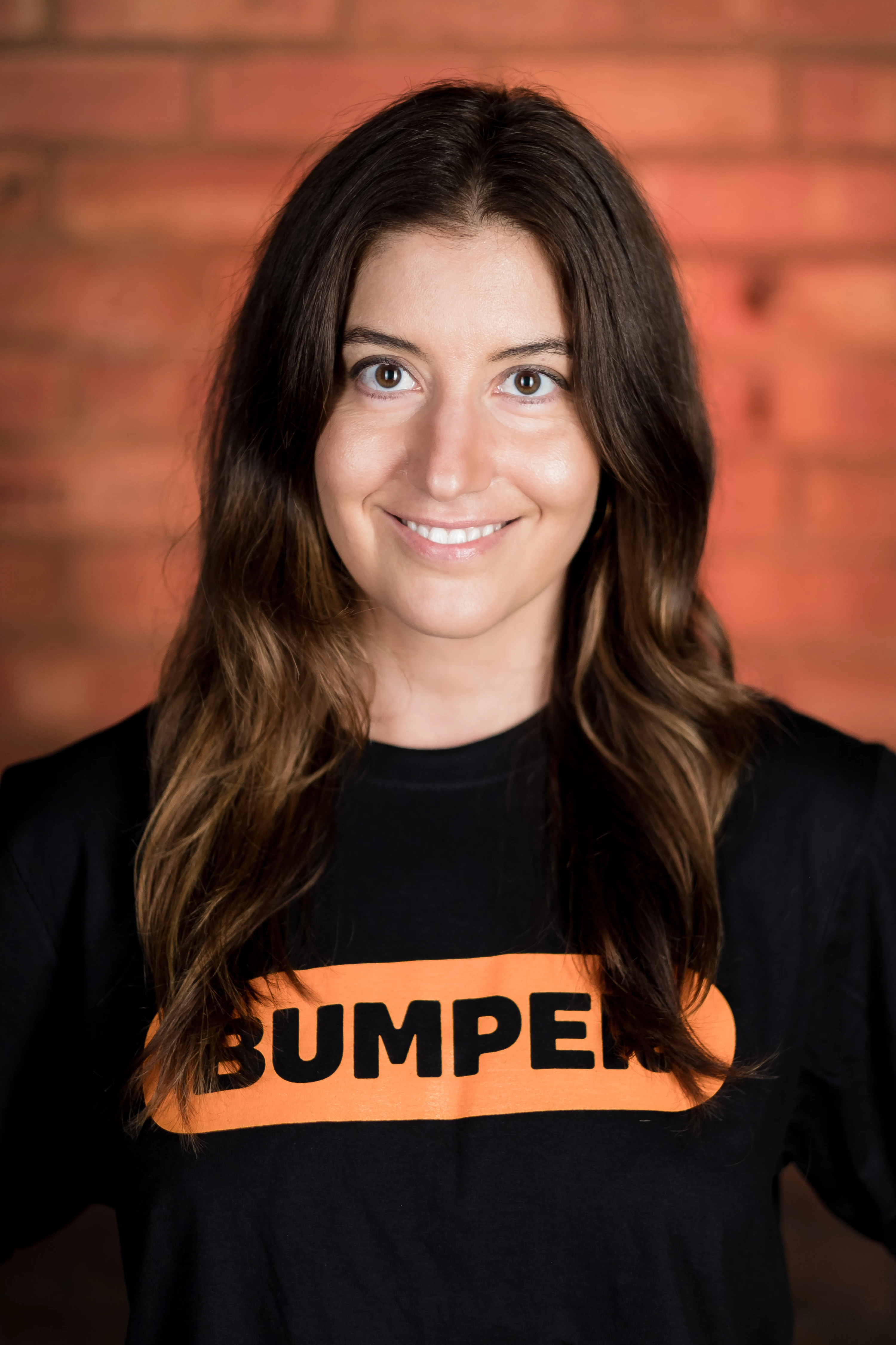 Bumper Team Photography - Individual headshot, branded Bumper t-shirt, exposed brick backdrop