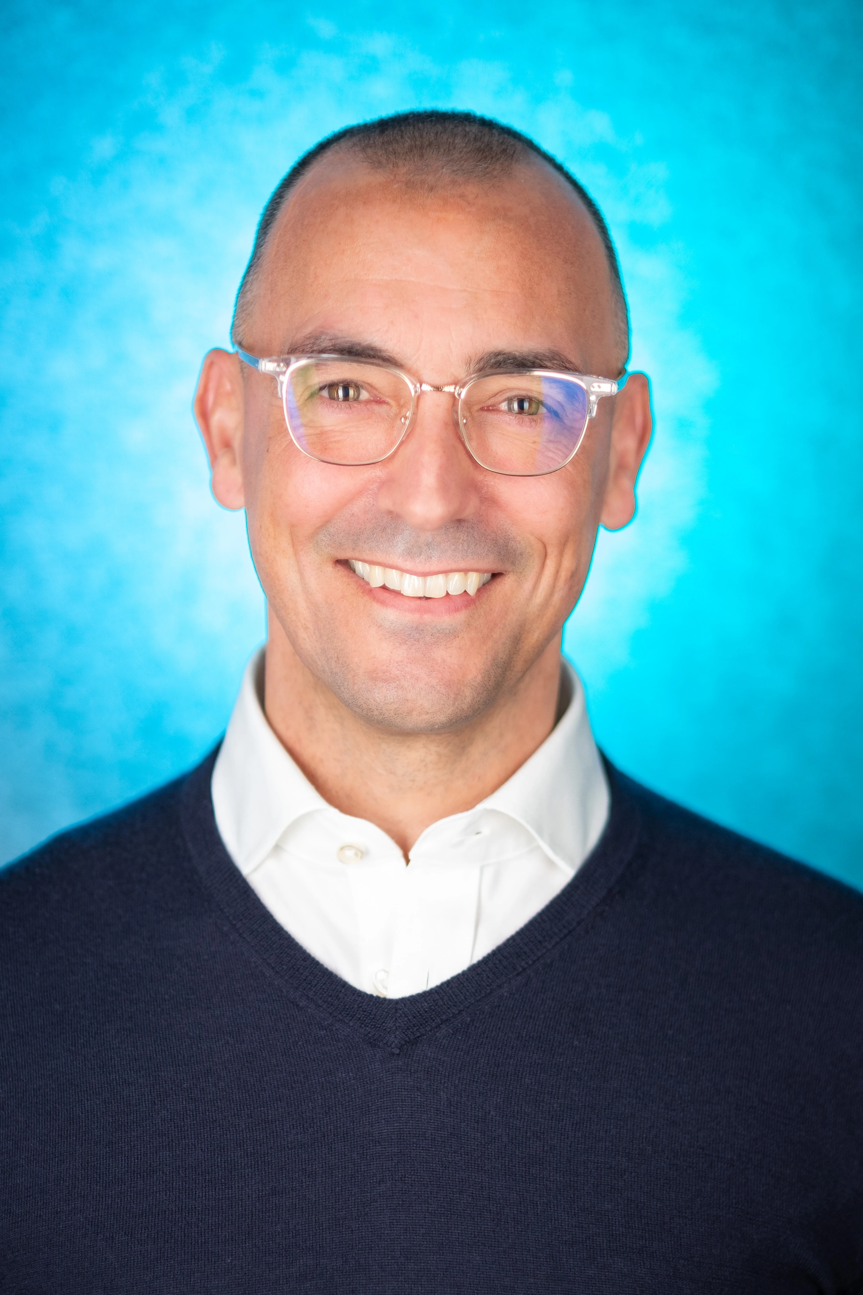 Thrasio Executive Headshots - Jim Mann, Director of Acquisitions, blue backdrop