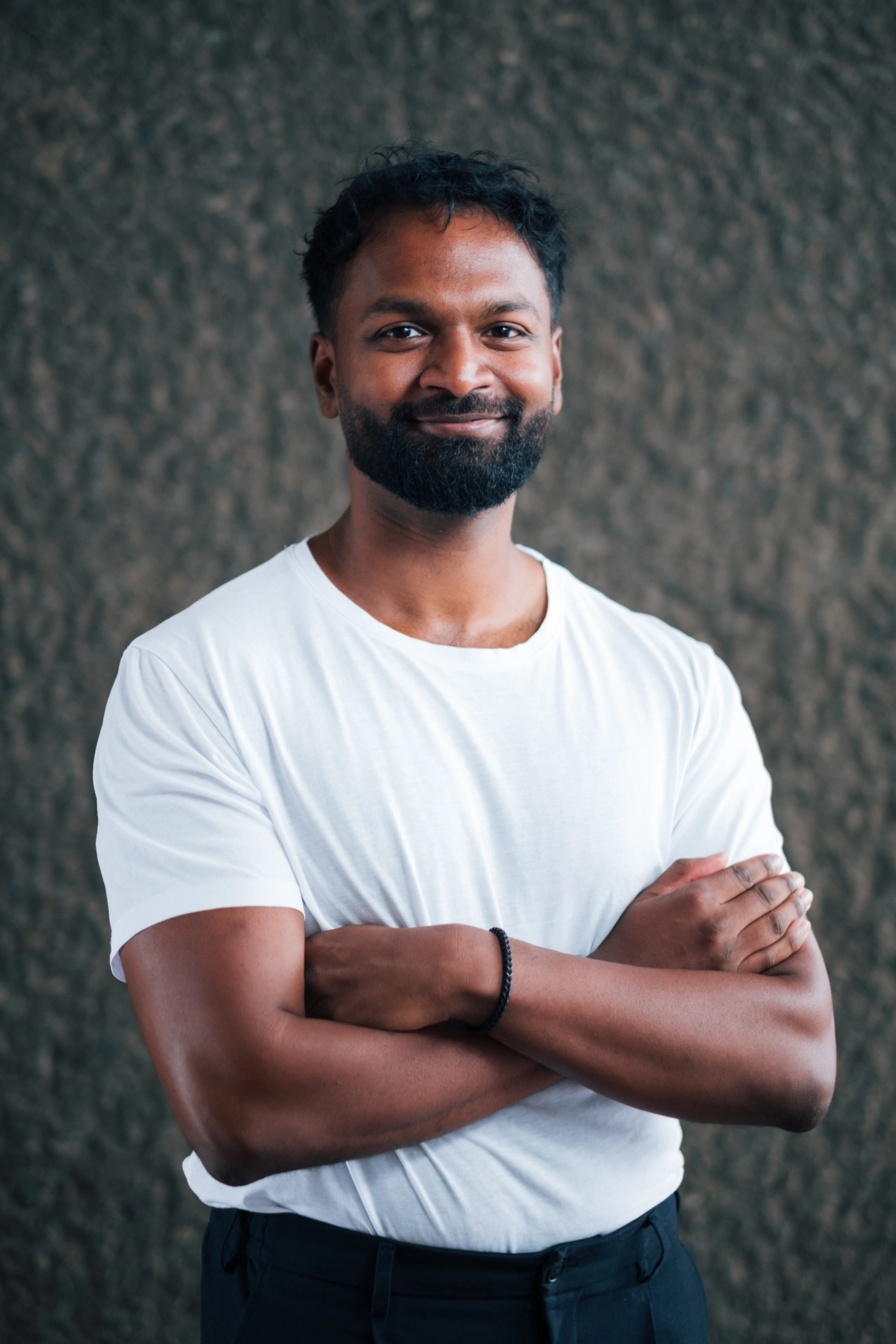 Zenithon AI Founders - Portrait of Abetharan Antony, co-founder, against textured concrete